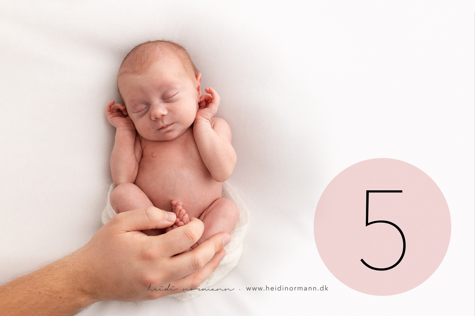 nyfødt baby I fars hånd